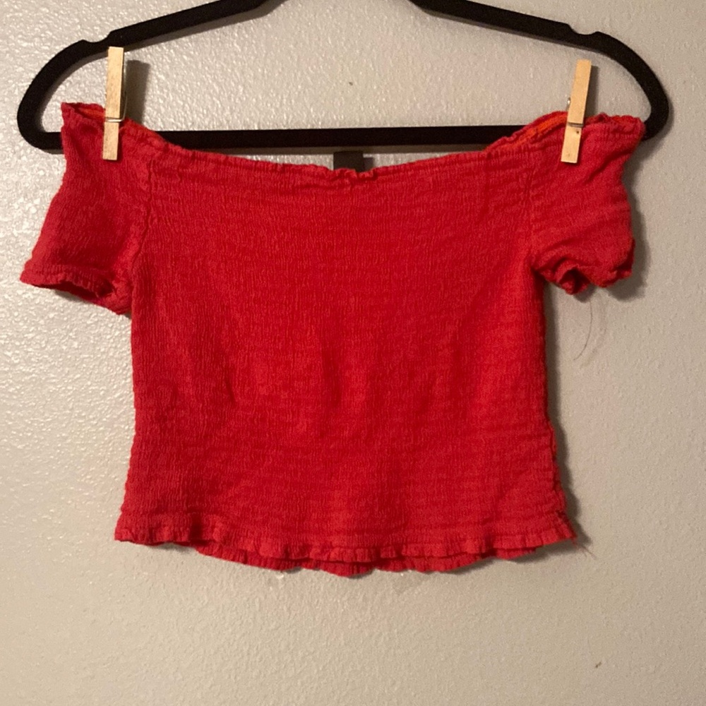 Red of the shoulder cropped top.